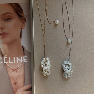 Close-up of adjustable long sweater chain featuring white pearl grape cluster pendants