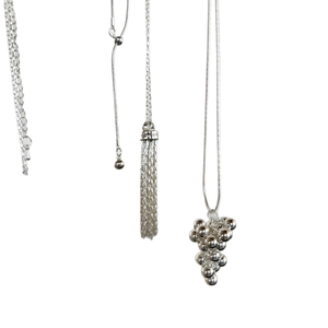 Silver grape cluster necklace with sleek snake chain and long metallic tassels