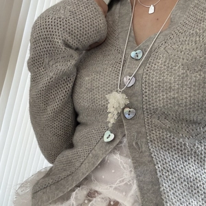 Detailed view of long adjustable silver necklace with white crystal grape cluster pendant