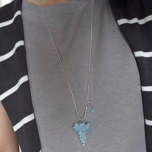 Blue crystal grape cluster pendant necklace on silver chain worn with casual outfit