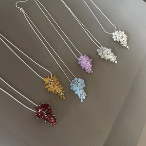 Close-up of adjustable long chain necklaces with colorful crystal grape clusters