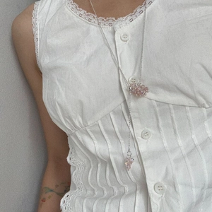 Detail of pink crystal flower pendant on a silver long adjustable chain necklace