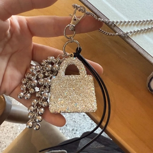 Detail of mini tote bag pendant with sparkling rhinestones and silver beaded charms