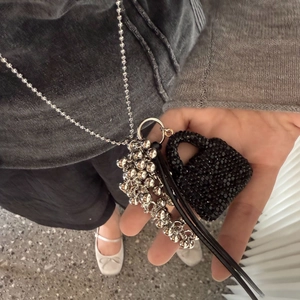 Silver bead chain necklace with black crystal heart pendant and metallic ball charms