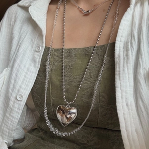 Minimalist silver heart pendant necklace with beaded chain layered for a stylish look