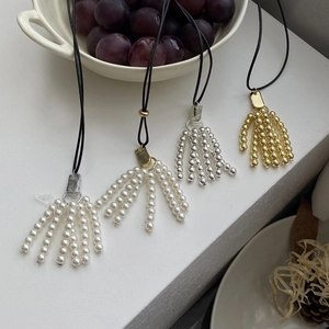 Long beaded necklaces with fringe pendants and minimalist black cord in assorted colors