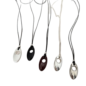 Minimalist silver and black oval pendant necklaces on black cord and metal chains