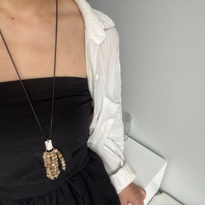 Detailed view of handmade beaded tassel necklace featuring natural stone and ethnic aesthetic