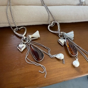 Maillard amber teardrop pendant necklace with silver heart clasp and white tassels