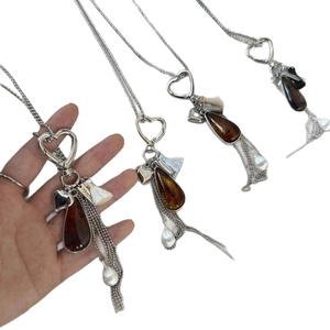 Vintage boho long necklace with amber teardrop pendant, heart charm, and silk tassels