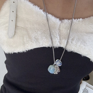 Detail of silver titanium steel long necklace featuring light blue natural stone beads