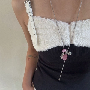 Detail of beaded necklace with pink stones and silver chain on a wool sweater