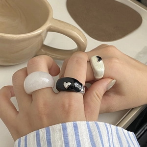 Détails de bagues en résine noire et marbre blanc avec breloques en forme de cœur