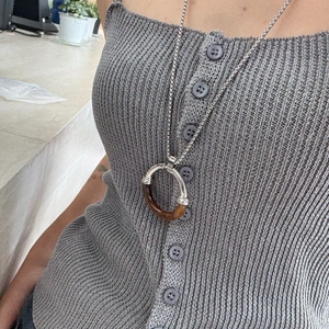 Long minimalist necklace featuring a large amber resin ring pendant on a silver chain