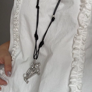 Minimalist silver dachshund puppy pendant necklace with adjustable black woven rope cord