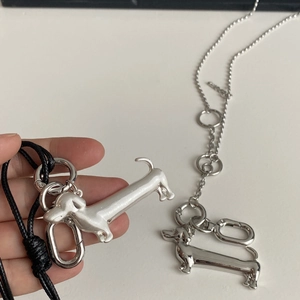Detail of dachshund dog pendant in matte and polished silver finish with chain