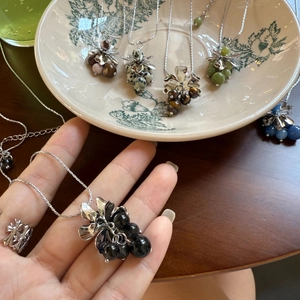Handmade grape cluster necklace featuring colorful natural stones and silver leaf accents
