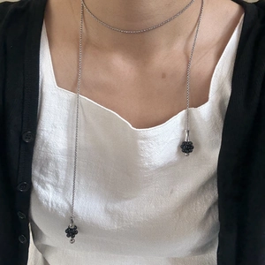 Silver long lariat necklace with black beaded ball pendants on a classic metal chain