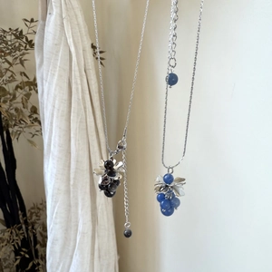 Detail of grape cluster pendant necklace featuring green and blue natural stones