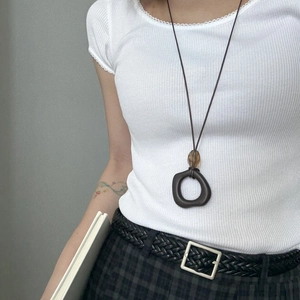 Minimalist brown resin circle pendant necklace with amber bead on long cord