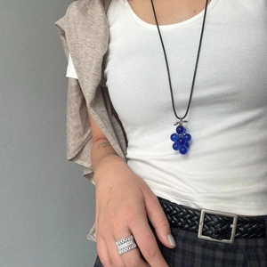 Detail of blue grape cluster bead necklace with silver leaf and black minimalist cord