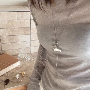 Minimalist gold and silver fish pendant necklaces on woven chains for women