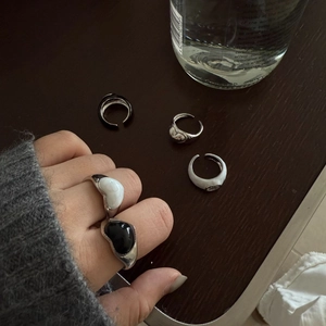 Minimalist open enamel rings with oval black and white stones in a retro stackable style