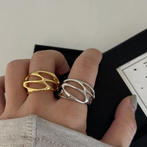 Detailed macro view of gold and silver plated cutout rings with modern geometric design