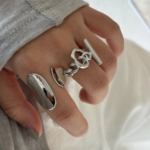 Close-up of minimalist silver open rings with hollow irregular and chain link designs