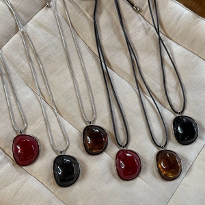 Irregular resin pebble pendants on silver snake chains and cords in autumn colors