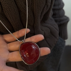 Maillard vintage resin irregular pendant necklace on brown sweater with silver snake chain