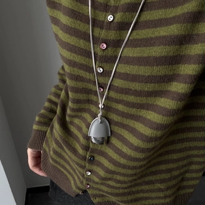 Olive green and brown striped knit cardigan with leather pine cone pendant necklace