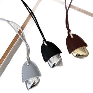 Chic leather clochette pendant necklace with metallic pebble charm on white background