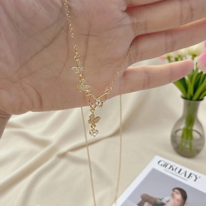 Handheld view of elegant gold butterfly necklace with sparkling zircon tassels