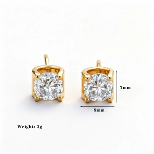 Macro shot of 7mm x 8mm gold-plated stud earrings featuring round cubic zirconia stones