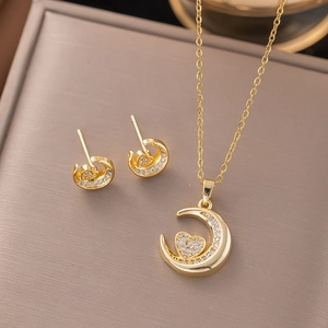 Golden necklace and earring set featuring micro-pave zircon crescent moon and heart charm