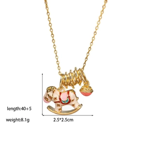 Detail of gold chain necklace with colorful enamel rocking horse and small red bell charm