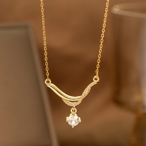 Detailed macro view of laurel leaf gold pendant with zircon crystal and pave setting