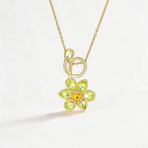 Elegant flower necklace with green pear-cut crystals and a central yellow gemstone