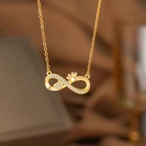 Goldener Unendlichkeitsanhänger mit Diamant-Herz und Pfote an einer feinen Kette