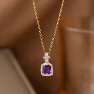 Detail of square purple gemstone pendant necklace with halo diamonds and gold chain
