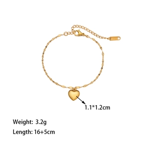 Detail of heart pendant bracelet in gold finish with K18 engraving and lobster clasp
