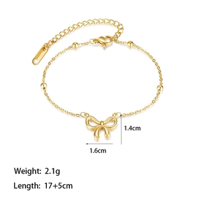 Macro detail of golden bow bracelet with metal beads showing dimensions and 17+5cm length