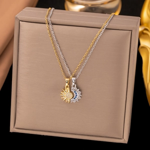 Retro gold sun and silver moon necklaces with crystals displayed in a premium jewelry box