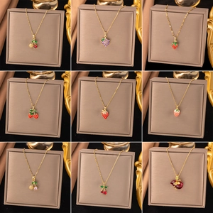 Gold titanium steel necklaces with colorful fruit pendants including cherry and strawberry