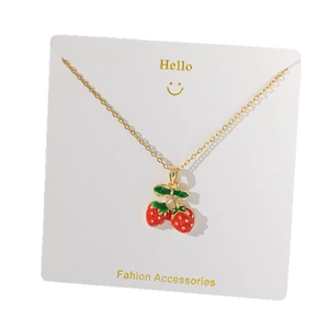 Elegant gold titanium necklace featuring a 3D red strawberry pendant on a white gift card