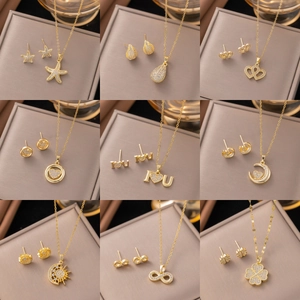 Macro view of nine luxury gold-plated jewelry sets featuring waterdrop and heart designs