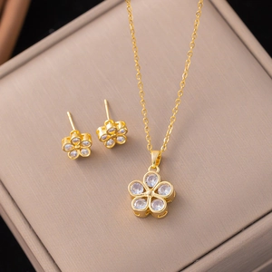 Detail of five-petal flower jewelry set with sparkling zircons on champagne silk