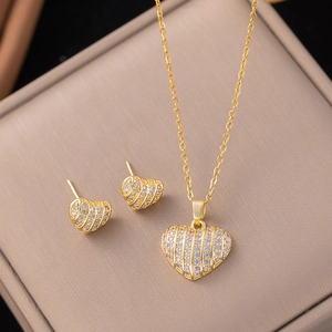 Detailed view of gold-plated heart necklace and earrings set with micro-pave zircons