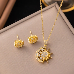 Close-up of golden sun and moon jewelry set with sparkling zircon on brushed box